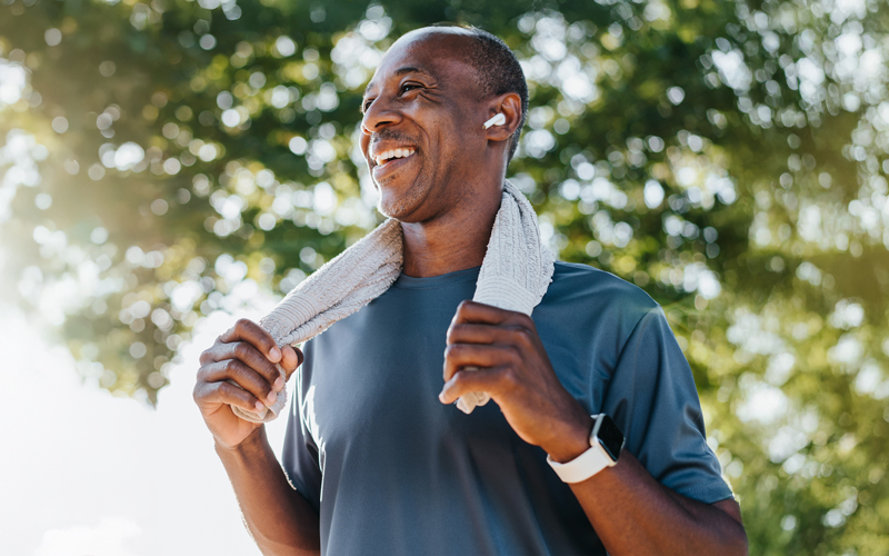 Photo of an older man after exercising with a towel around his neck