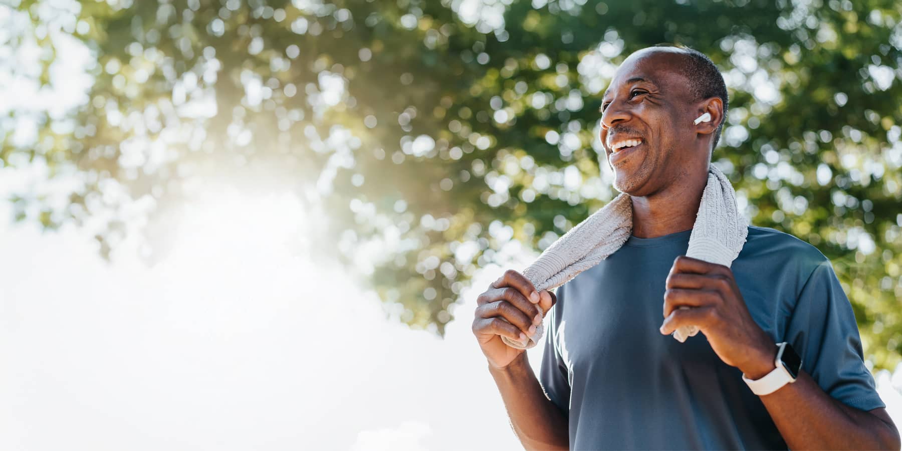 Photo of an older man after exercising with a towel around his neck